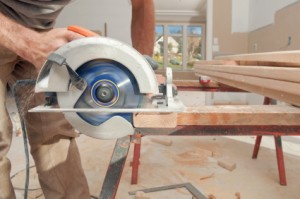 Woodworking employee using circular saw