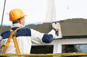 Plasterers tradesman liability cover quotes Tradesman at plastering a wall